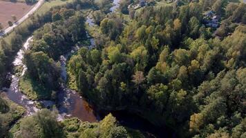 Aerial View of Winding River Through Forested Area with Houses video