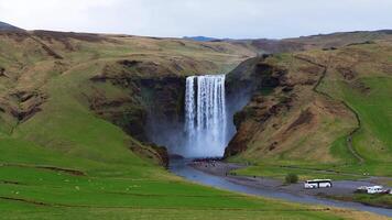 Skogafoss Waterfall with Tourists and Vehicles in Iceland video