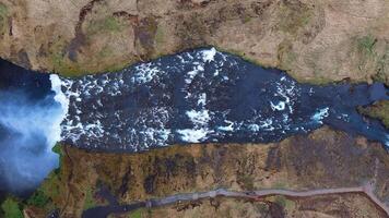 Aerial View of Skogafoss Waterfall and Rugged Icelandic Terrain video
