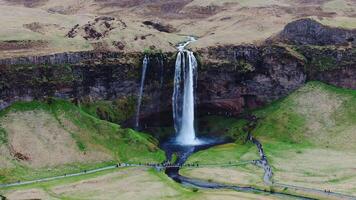 Seljalandsfoss Waterfall with Visitors on Path in Iceland video