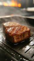Grilling tender beef steaks to perfection in a kitchen on a smoky evening photo
