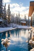Luxurious winter retreat with a serene swimming pool surrounded by snow-covered trees photo