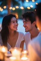 Romantic candlelight dinner on the beach during sunset with a couple enjoying their moment photo