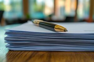 Desk with a stack of blank papers and a pen on a sunny day in a garden setting photo