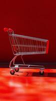 Empty shopping cart against a vibrant red background in a minimalistic setting photo
