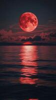 Majestic full moon reflecting on calm waters during twilight photo