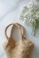 Woven basket with delicate white flowers on marble surface in natural light photo