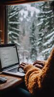 Focused individual working on laptop in cozy indoor space with plants and warm lighting photo
