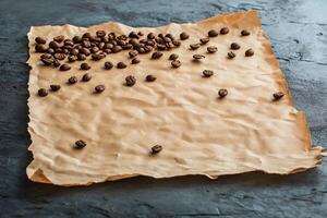Coffee beans scattered on brown parchment paper creating a rustic feel in a kitchen setting photo