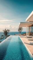 Beautiful infinity pool overlooking the ocean under a clear sky with palm trees photo