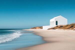 Serene view of white building by the turquoise sea under a clear sky on a sunny day photo