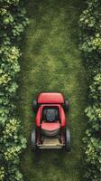Red lawn mower parked on lush green grass in bright daylight photo