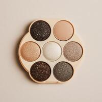 Elegant eyeshadow palette showcasing neutral and sparkly shades for versatile makeup looks photo
