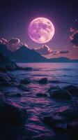 Majestic purple moon illuminating ocean waves and rocky coastline at dusk photo