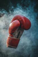 Boxing glove in motion creating a dramatic atmosphere with dust and mist photo