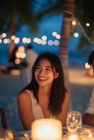 Romantic candlelight dinner on the beach during sunset with a couple enjoying their moment photo