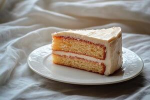 Delicious slice of cake with creamy frosting and a red topping on a plate in natural light photo