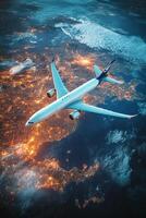 Airplane flying over a city illuminated at night above the Earth photo