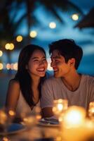 Romantic candlelight dinner on the beach during sunset with a couple enjoying their moment photo