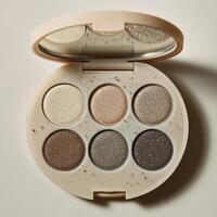 Elegant eyeshadow palette showcasing neutral and sparkly shades for versatile makeup looks photo