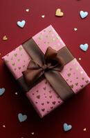 Colorful gift box with a bow on a red surface scattered with heart decorations photo