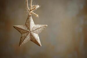 Hanging decorative star ornament against a rustic background in soft light photo
