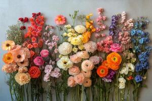Colorful flower arrangement showcasing various blooms on a neutral backdrop photo