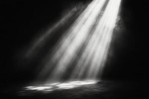 Light beams breaking through a dusty window in a dark, empty room during the late afternoon photo