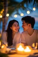 Romantic candlelight dinner on the beach during sunset with a couple enjoying their moment photo