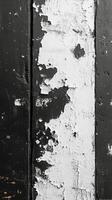 Peeling paint on a wooden surface highlights textures and contrasts in black and white photo