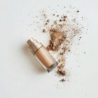 Powder foundation spilled beside its container on a plain background photo