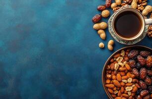 Warm cup of coffee with dried fruits and nuts on a vibrant blue surface photo