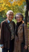 Elderly couple enjoying a sunny day at the park surrounded by nature and vibrant flowers photo