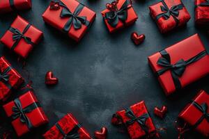 Celebratory red gift boxes with black ribbons arranged on dark background for special occasions photo