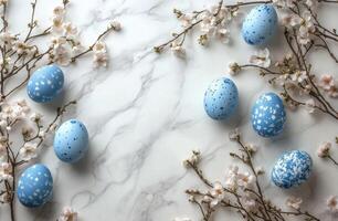 Sweet rabbit with blue eggs and spring flowers on marble surface during Easter celebration photo