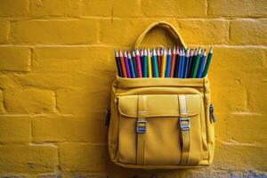 Colorful pencils in a yellow backpack against a blurred outdoor background during daytime photo