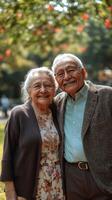 Elderly couple enjoying a sunny day at the park surrounded by nature and vibrant flowers photo