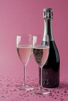 Romantic celebration with sparkling rose wine and heart confetti on pink background photo