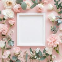 Floral arrangement with blank paper in soft pink hues on neutral background photo
