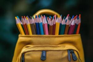 Colorful pencils in a yellow backpack against a blurred outdoor background during daytime photo