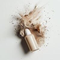 Powder foundation spilled beside its container on a plain background photo