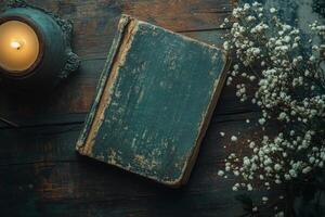 Rustic wooden table with open book and flower vase in cozy room photo