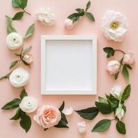Floral arrangement with blank paper in soft pink hues on neutral background photo