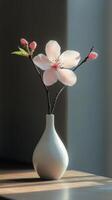 Elegant pink flower in a simple white vase against a soft gray background photo