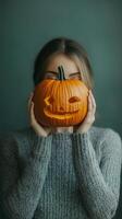 Woman holding a pumpkin in an autumn field with golden foliage photo