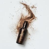 Powder foundation spilled beside its container on a plain background photo