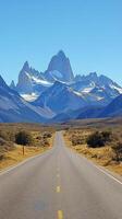 Scenic mountain landscape with a winding dirt road surrounded by lush forest photo