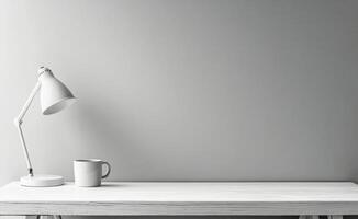 Elegant lamp and white mug on a wooden table against a soft gray wall photo