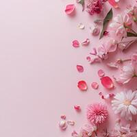 Delicate cherry blossom petals scattered on a soft pink background photo