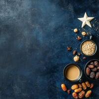 Fresh dates, spices, and coffee on a dark blue backdrop create a rich culinary experience photo